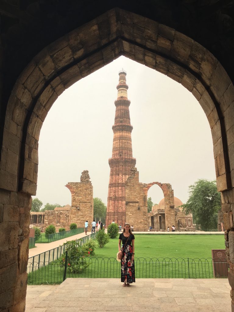 Sara in front of the Qutub Minar in Delhi, India