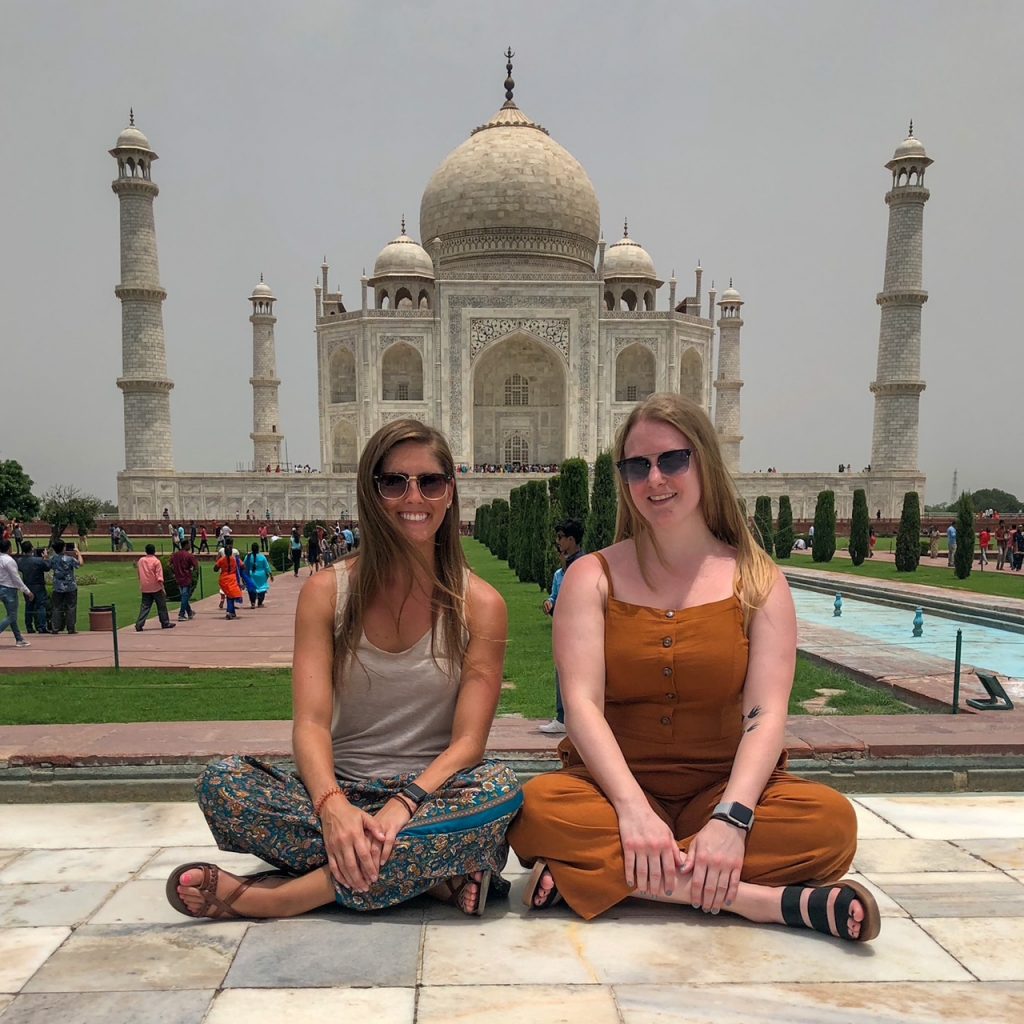 Sara and Candace sitting in front of the Taj Mahal