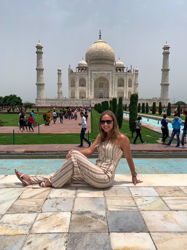 Tammy sitting in front of the Taj Mahal
