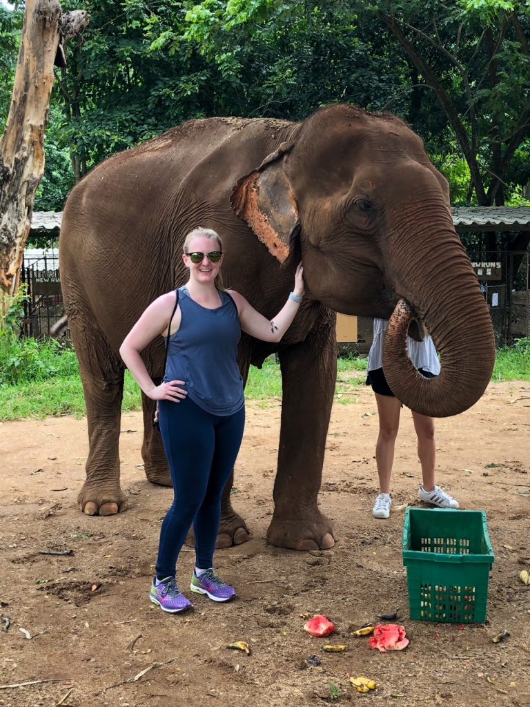 Candace with an elephant eating at the Elephant Nature Park