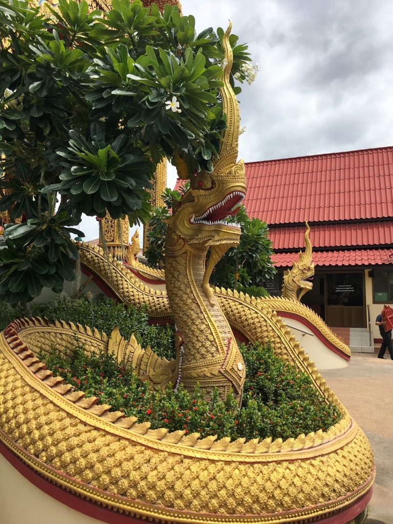 a dragon statue outside of a temple in Thailand