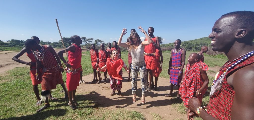Sara from Travel A-Broads high jumping with the Maasai tribe during their Maasai village visit