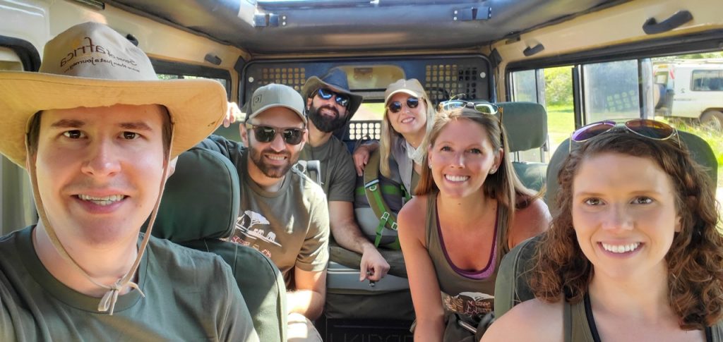 Three couples in their safari vehicle on a game drive in the Maasai Mara