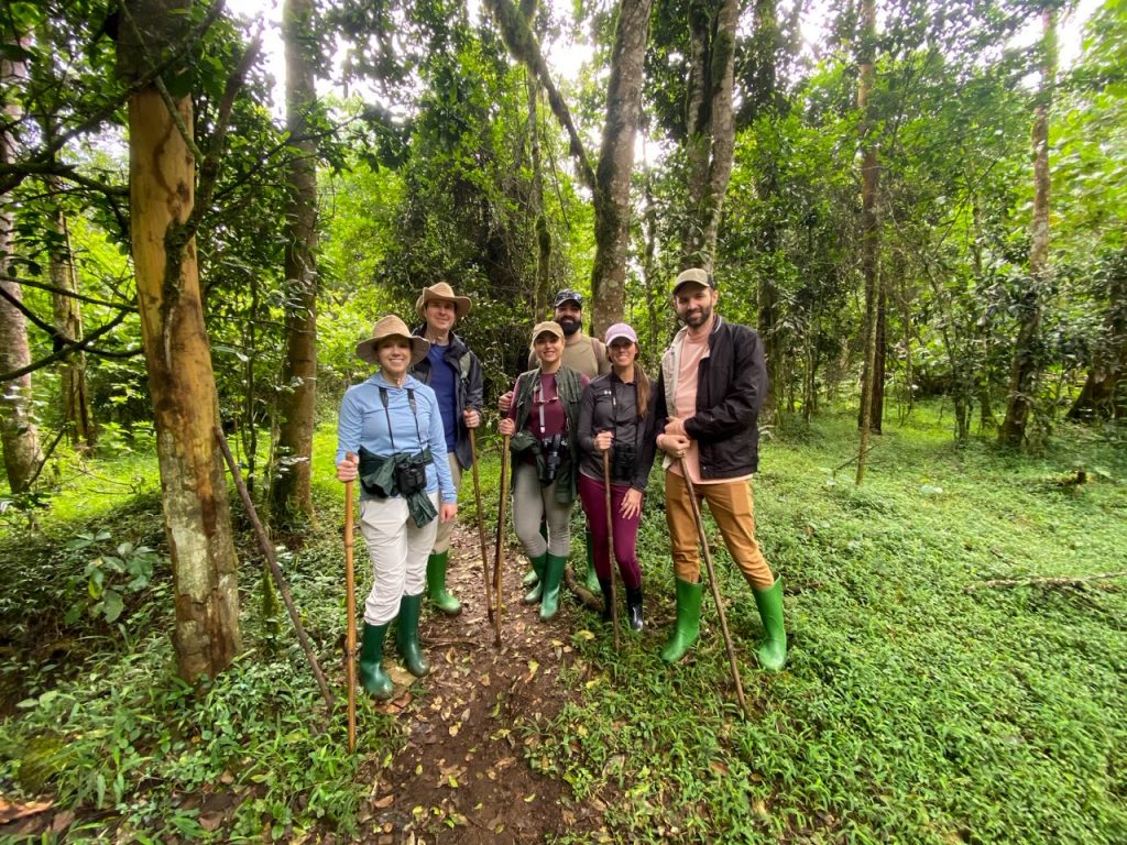 three couples decked out in rain and hiking gear on a guided nature walk through Mount Kenya National Park in central Kenya
