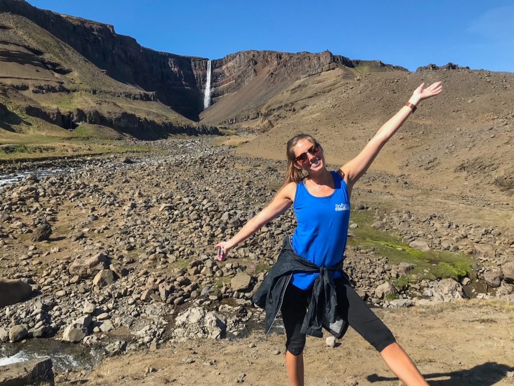 Sara presenting Hengifoss, Iceland’s third tallest waterfall, in the background