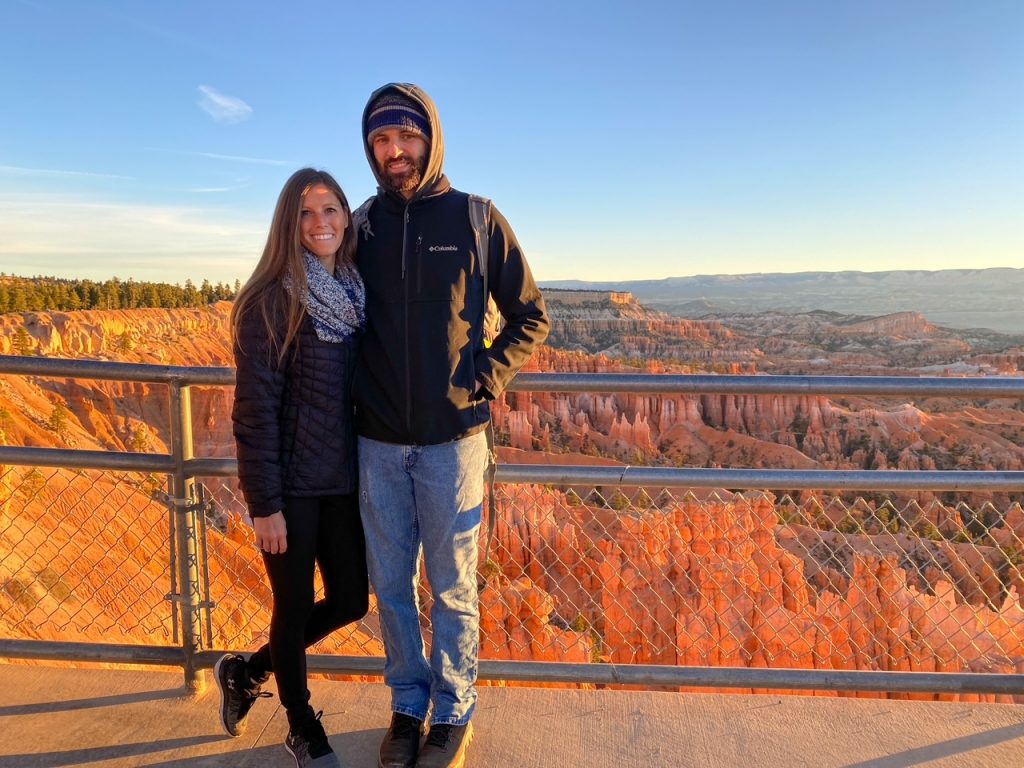 Sara and Tim all bundled up at sunrise at Sunset Point in Bryce Canyon in October