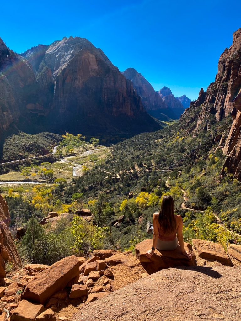 Sara overlooking the Walter’s Wiggles switchbacks while hiking Angels Landing in Zion National Park, the first stop on the Utah Mighty Five road trip