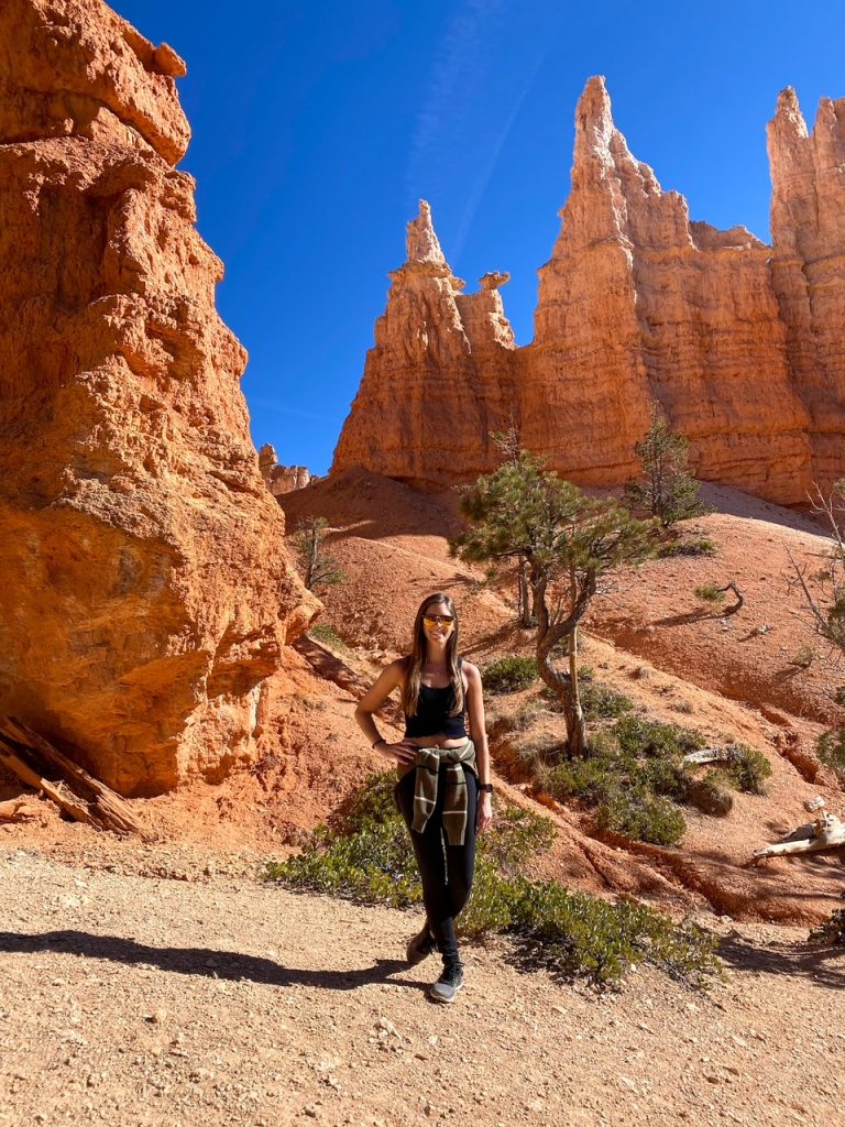 Sara standing in front of the Queen Victoria hoodoo in Bryce Canyon National Park