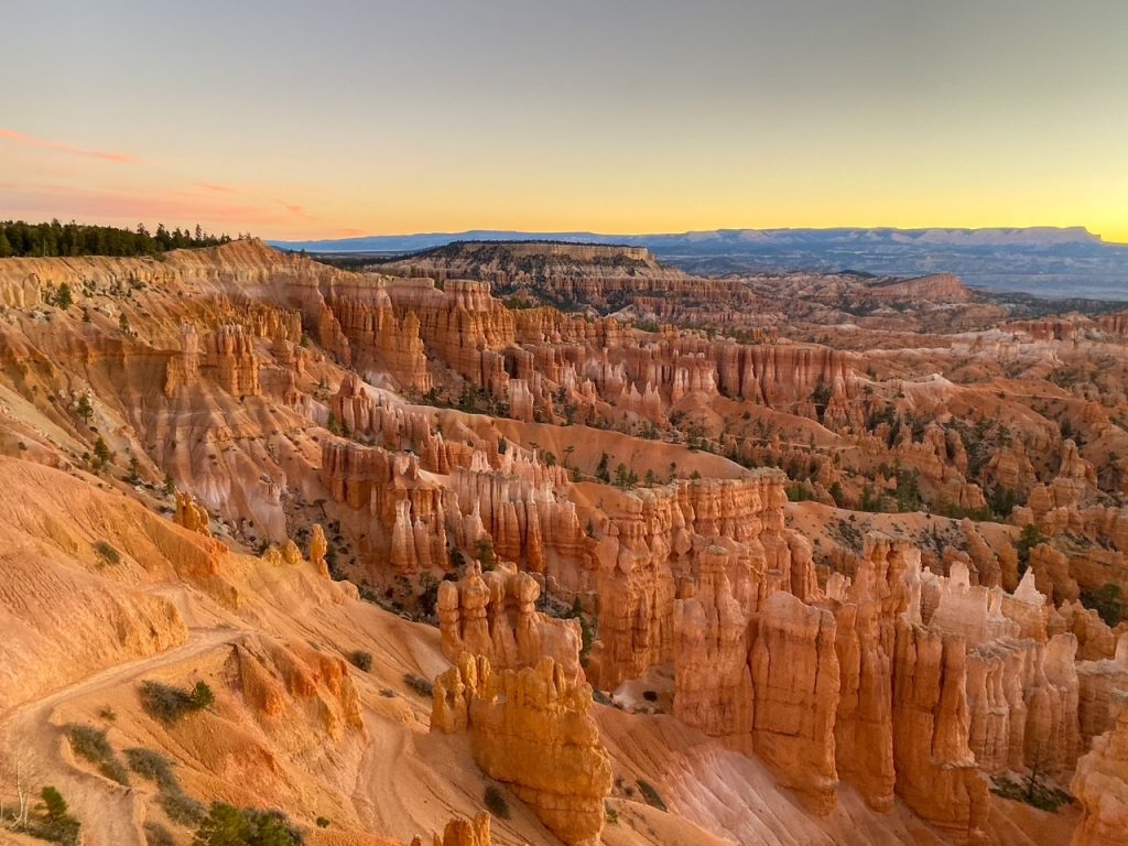 a gold and pink October sunrise as seen from Sunset Point in Bryce Canyon National Park