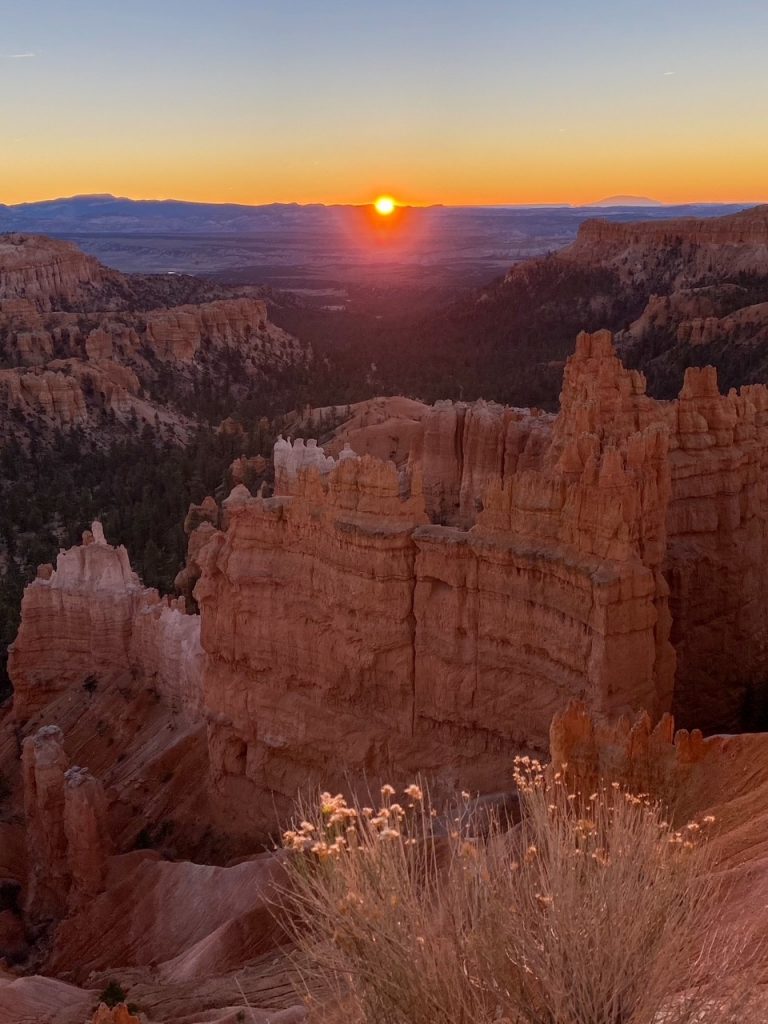 the sun starting to rise over the hoodoos at Sunset Point in Bryce Canyon National Park