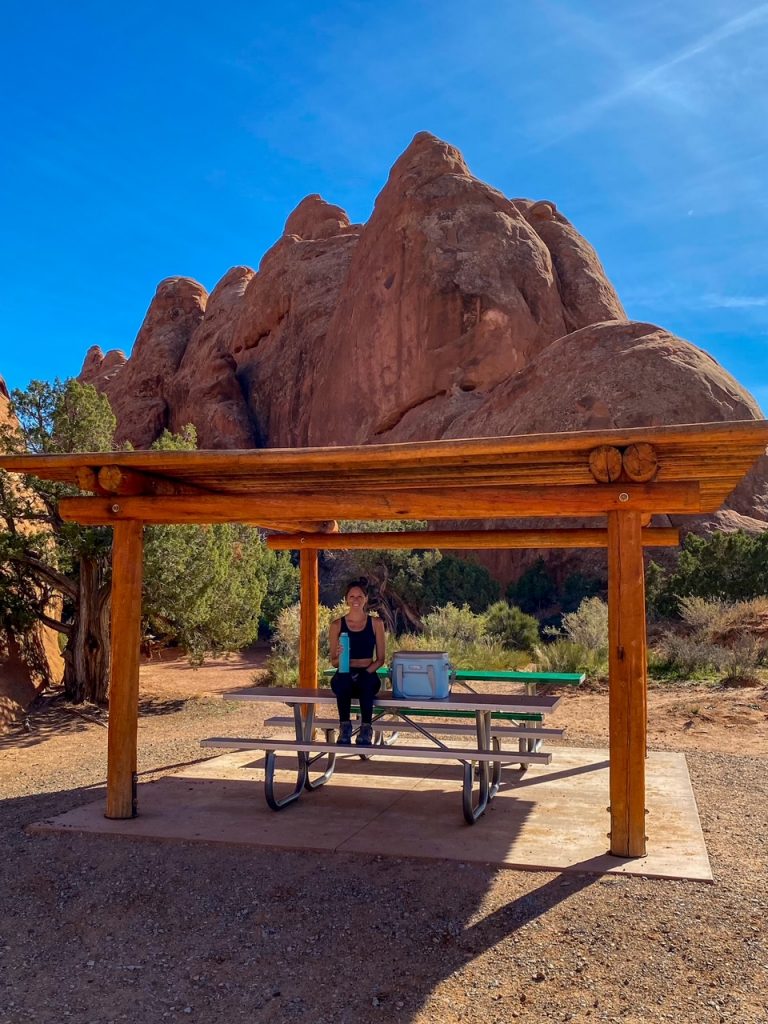 using our new RTIC cooler and having lunch at a picnic table inside Arches National Park in between all of our hiking