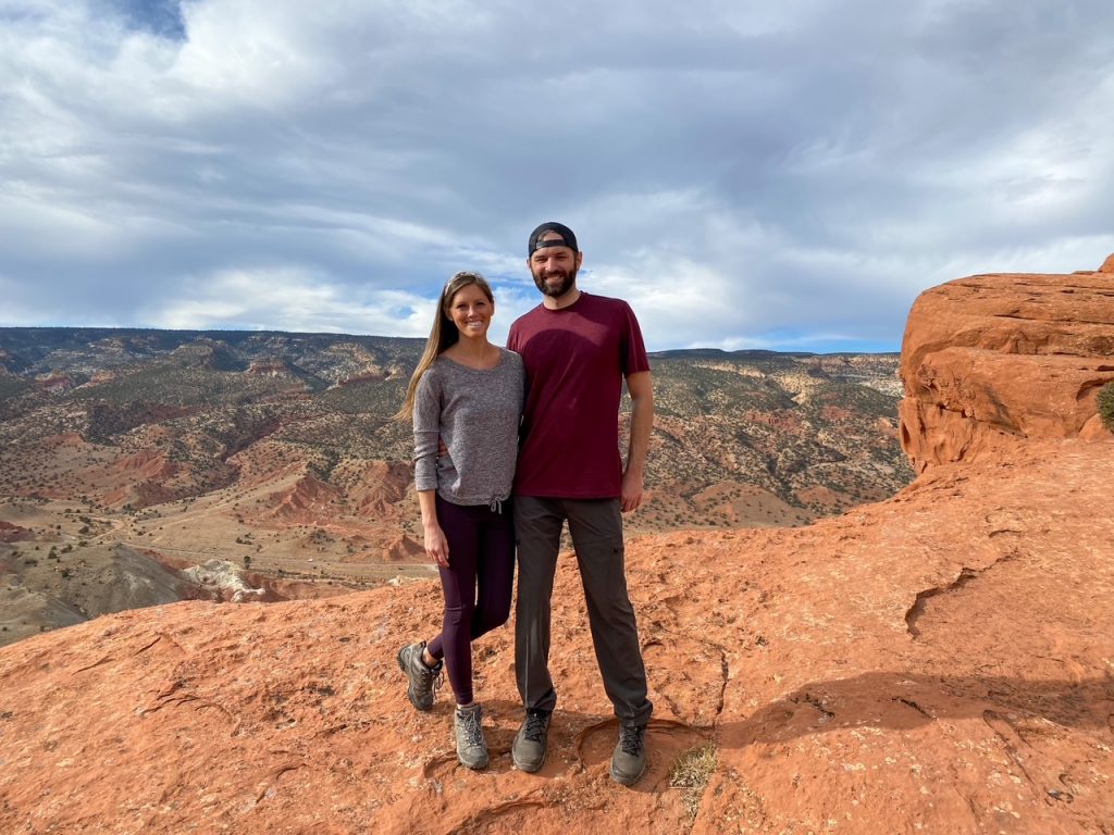 Sara and Tim in front of a gorgeous canyon view along the Cassidy Arch Trail in Capitol Reef