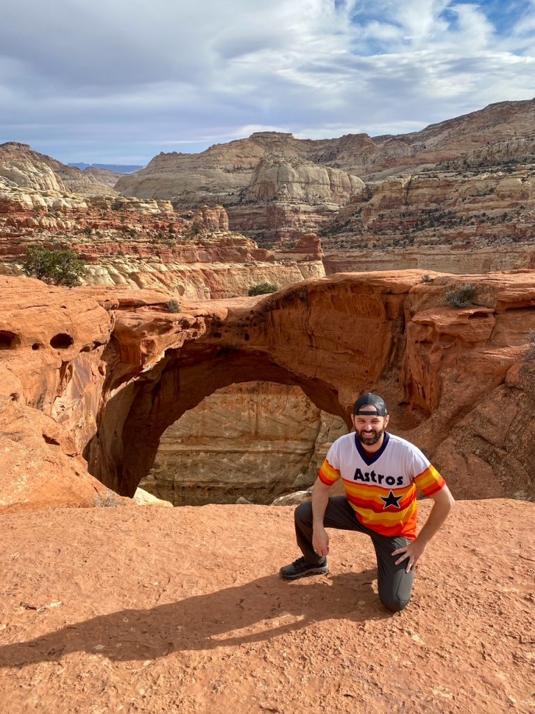 Tim posing in front of Cassidy Arch in Capitol Reef National Park