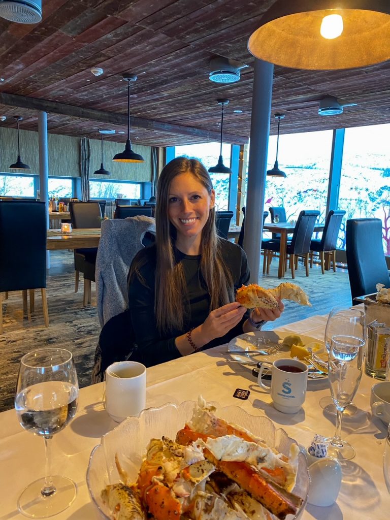 Sara eating Norwegian King crab legs at the Snowhotel Kirkenes