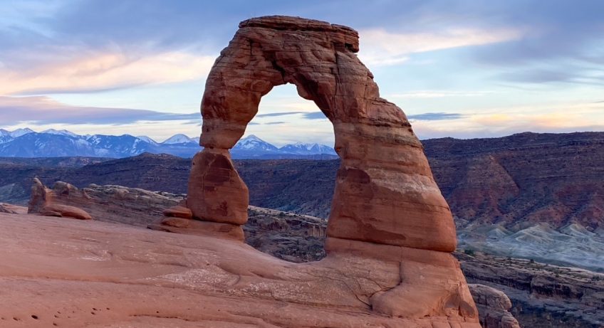 a breathtaking view of Delicate Arch at sunset in Arches National Park