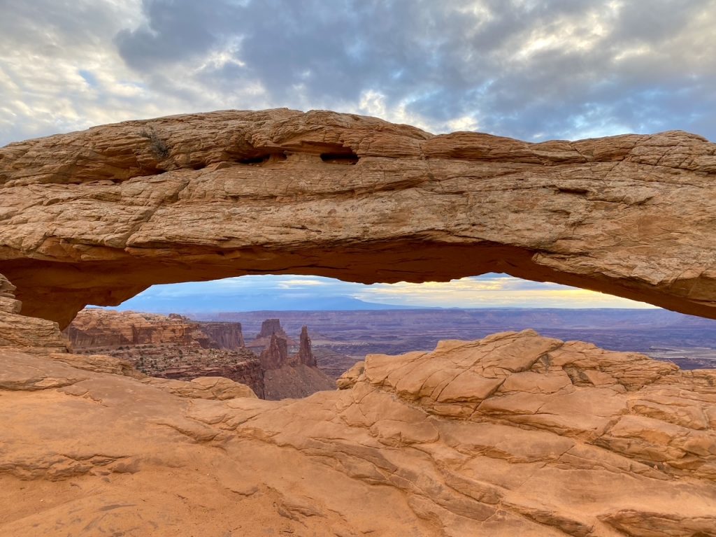 Mesa Arch lit by sunrise in Canyonlands National Park, a top photo spot on a Utah Mighty Five itinerary