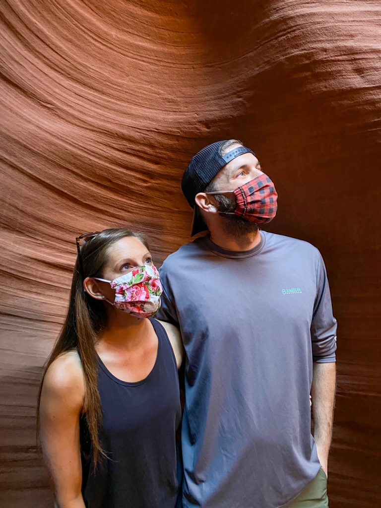 Sara and Tim posing for their guide and acting pensive inside Lower Antelope Canyon during Covid