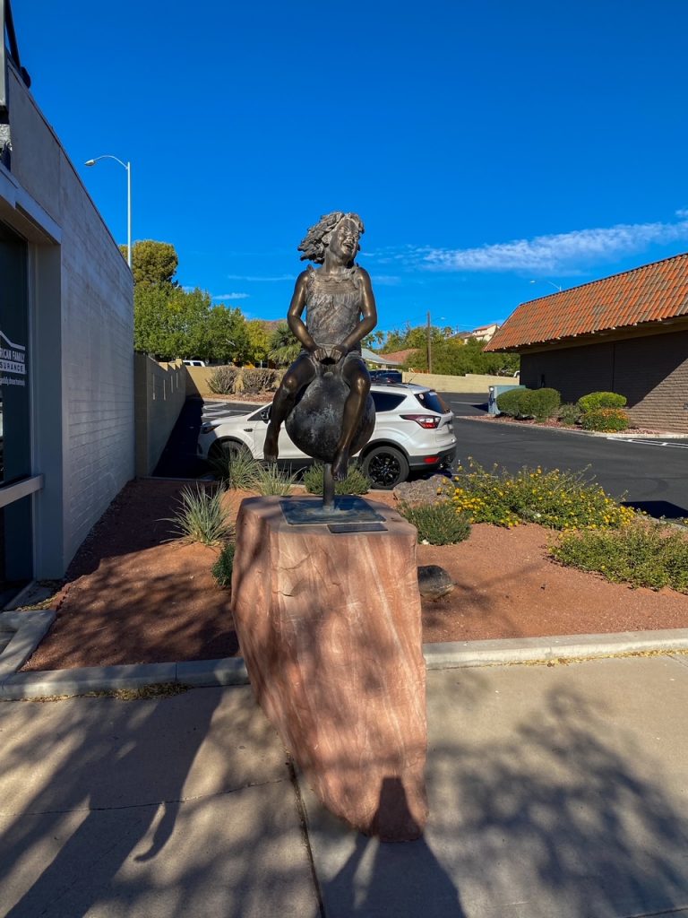 a sculpture of a child with a ball in Boulder City