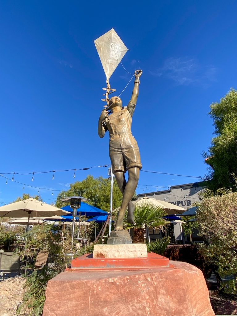 a sculpture of a child with a kite in Boulder City