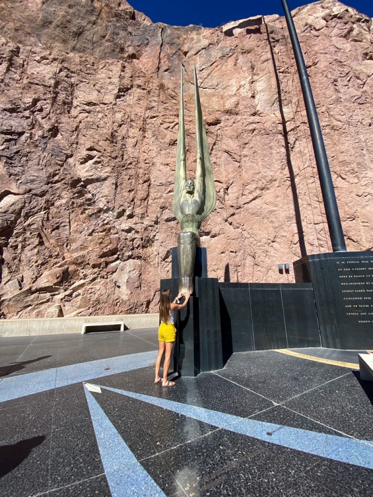 rubbing the angel's feet for good luck at the Hoover Dam