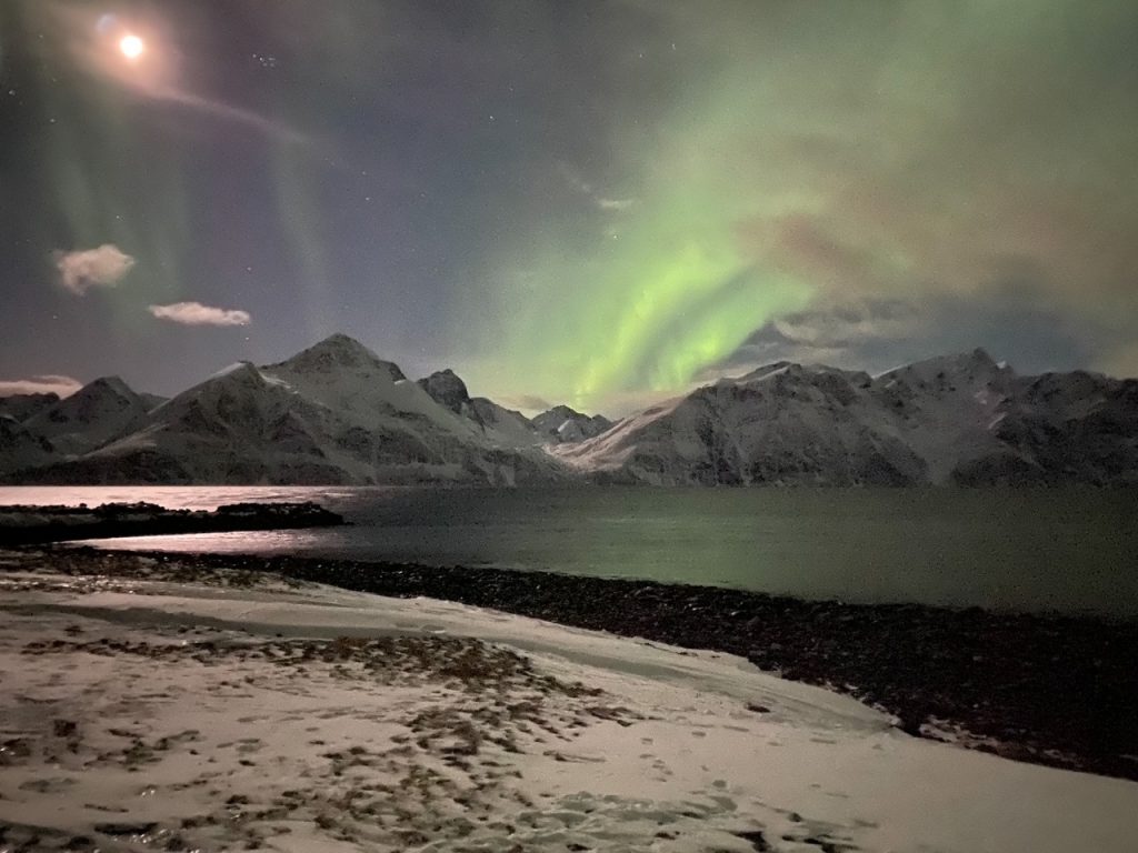 the Northern Lights over the Lyngen Alps in Rotsund, Norway in February