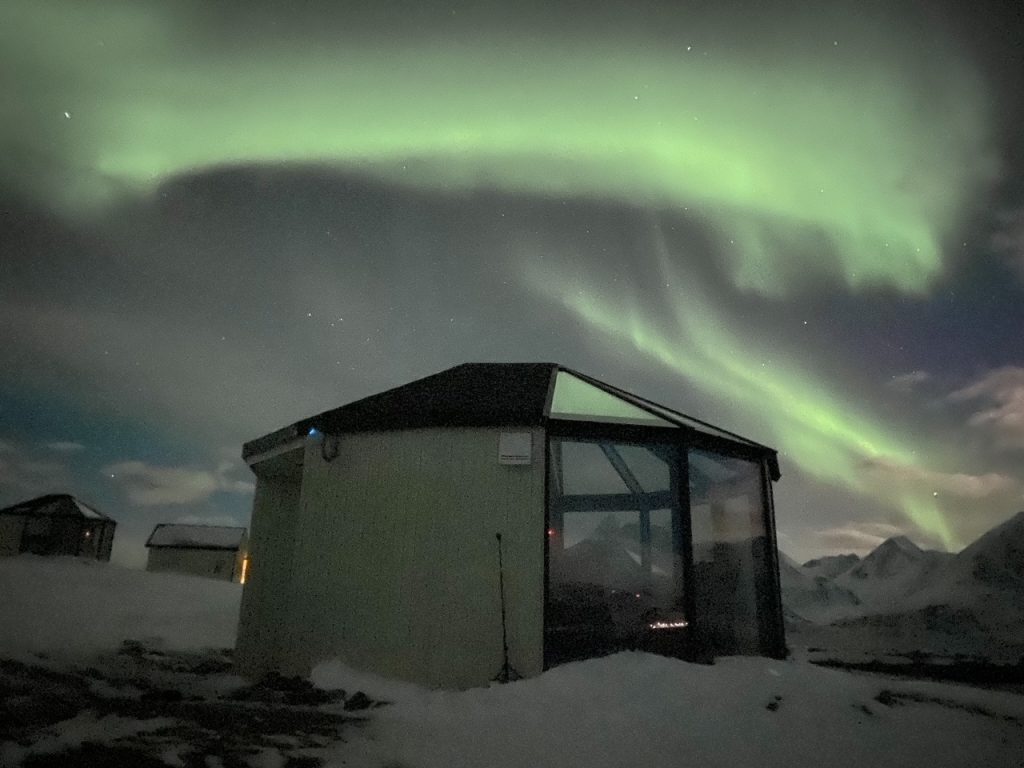 the Northern Lights over the 180 degree igloo at Lyngen North Igloo Hotel