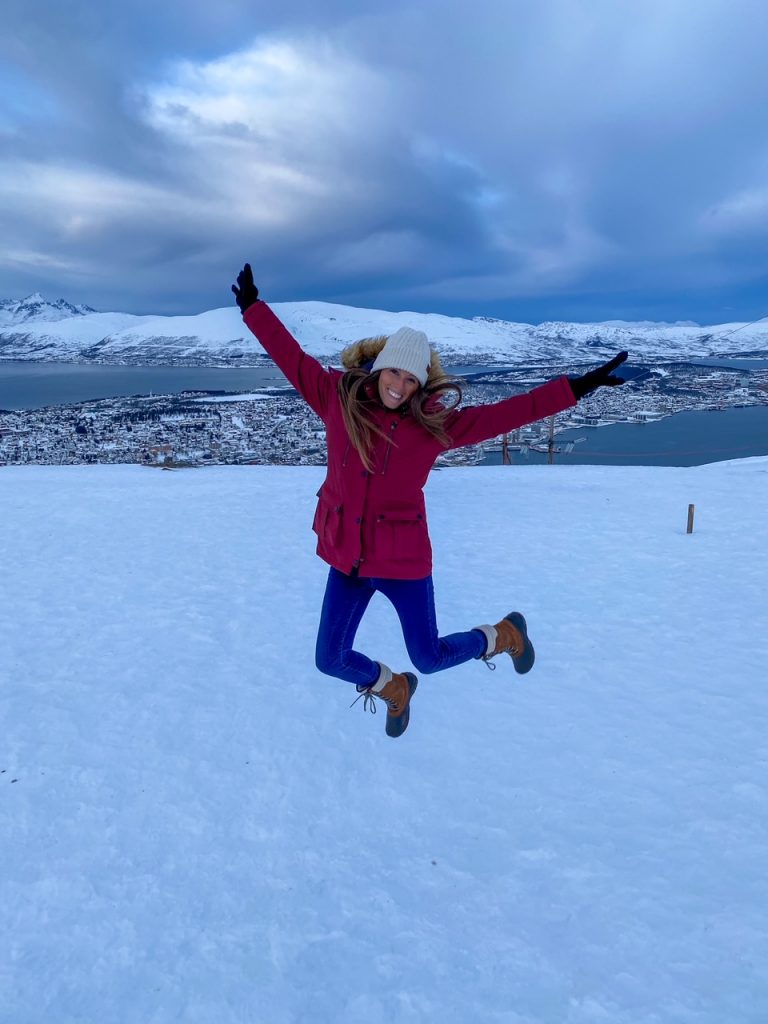 Sara jumping on Storsteinen mountain in Norway