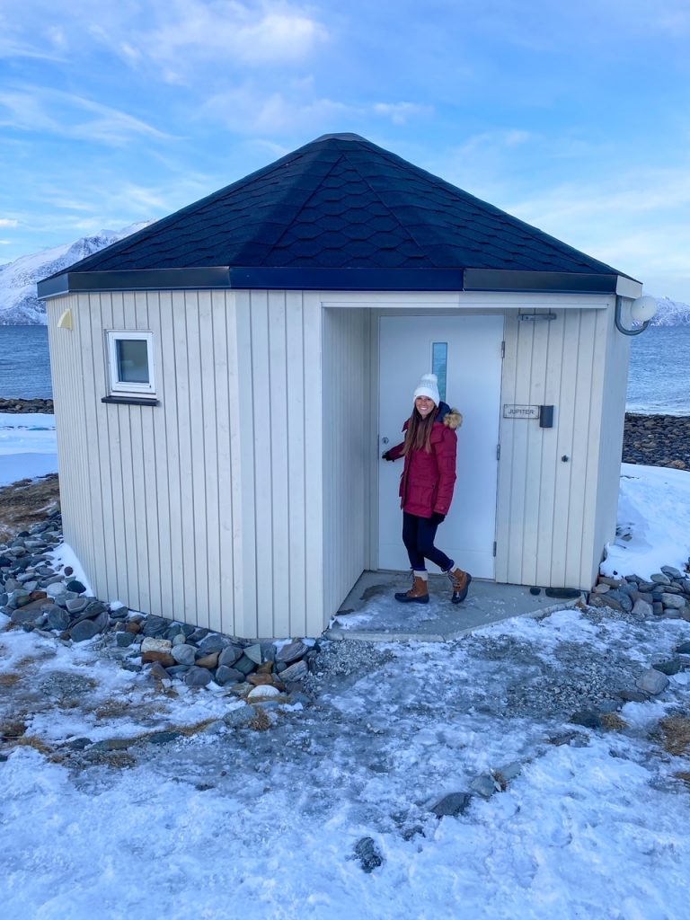 Sara walking into the 180 degree glass igloo at Lyngen North Igloo Hotel