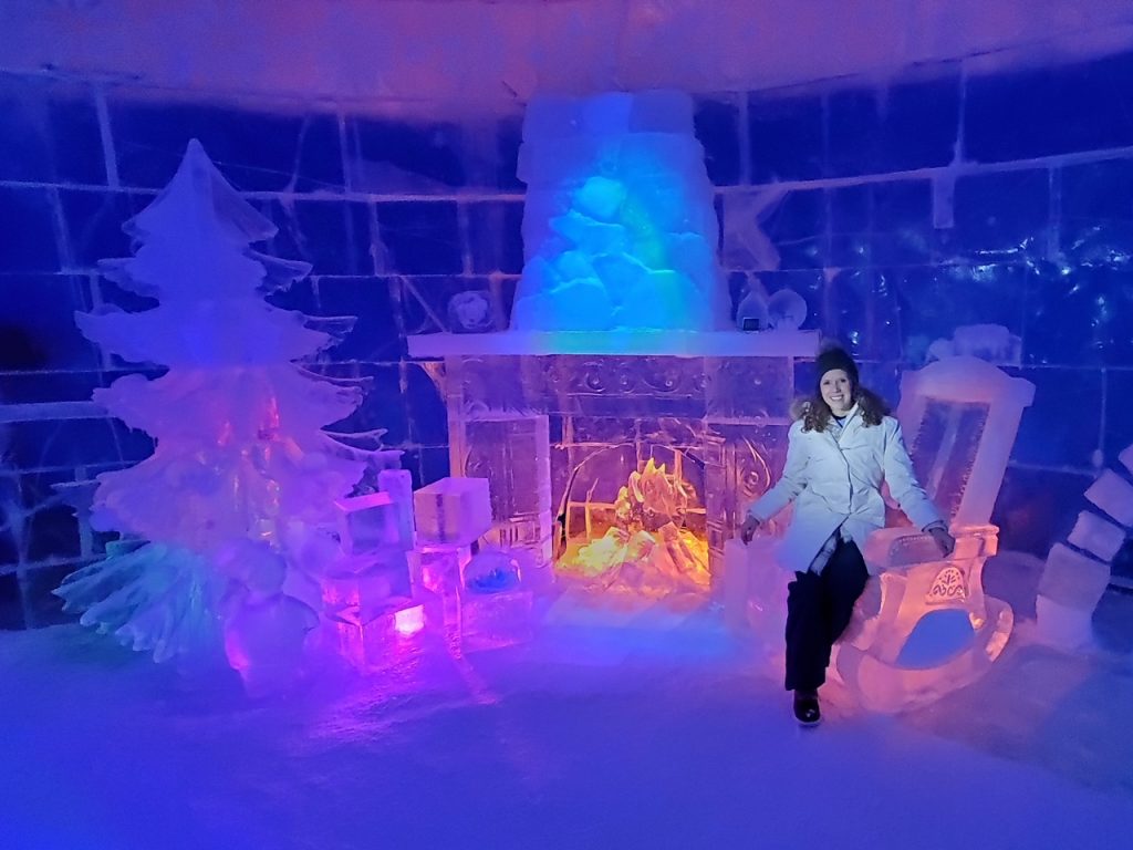 Allison posing with the ice sculpture fire place at the Snowhotel Kirkenes