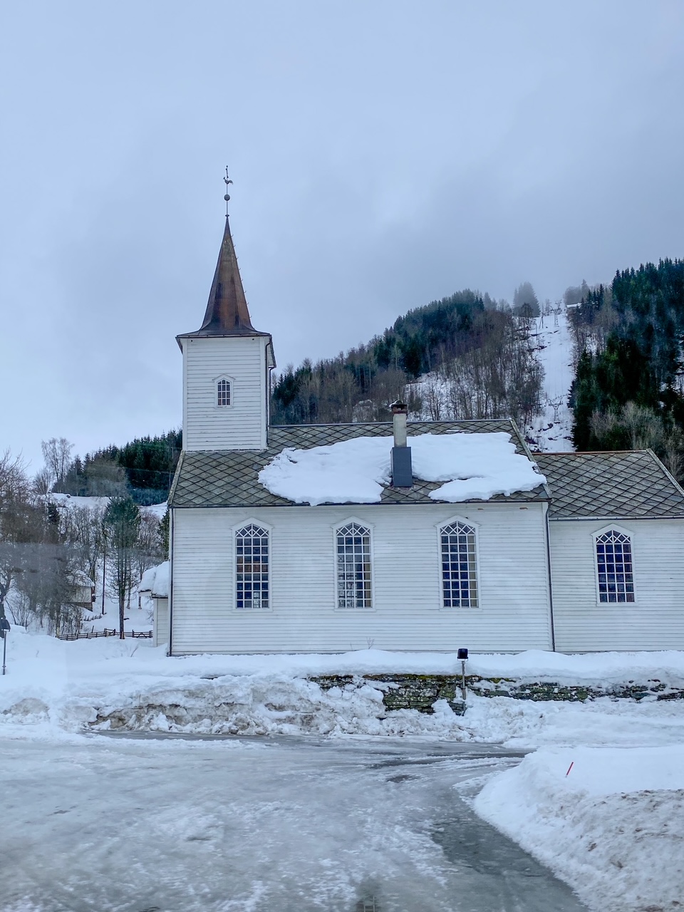 a white, old, wooden church on the bus ride from Voss to Gudvangen