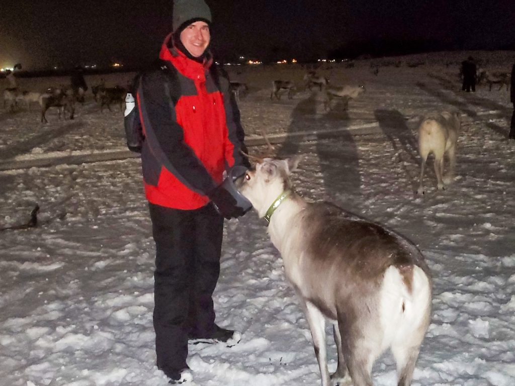 Ryan feeding a reindeer in Tromsø