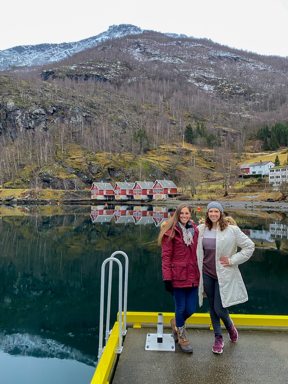 Sara & Allison in front of some charming red houses in Flam