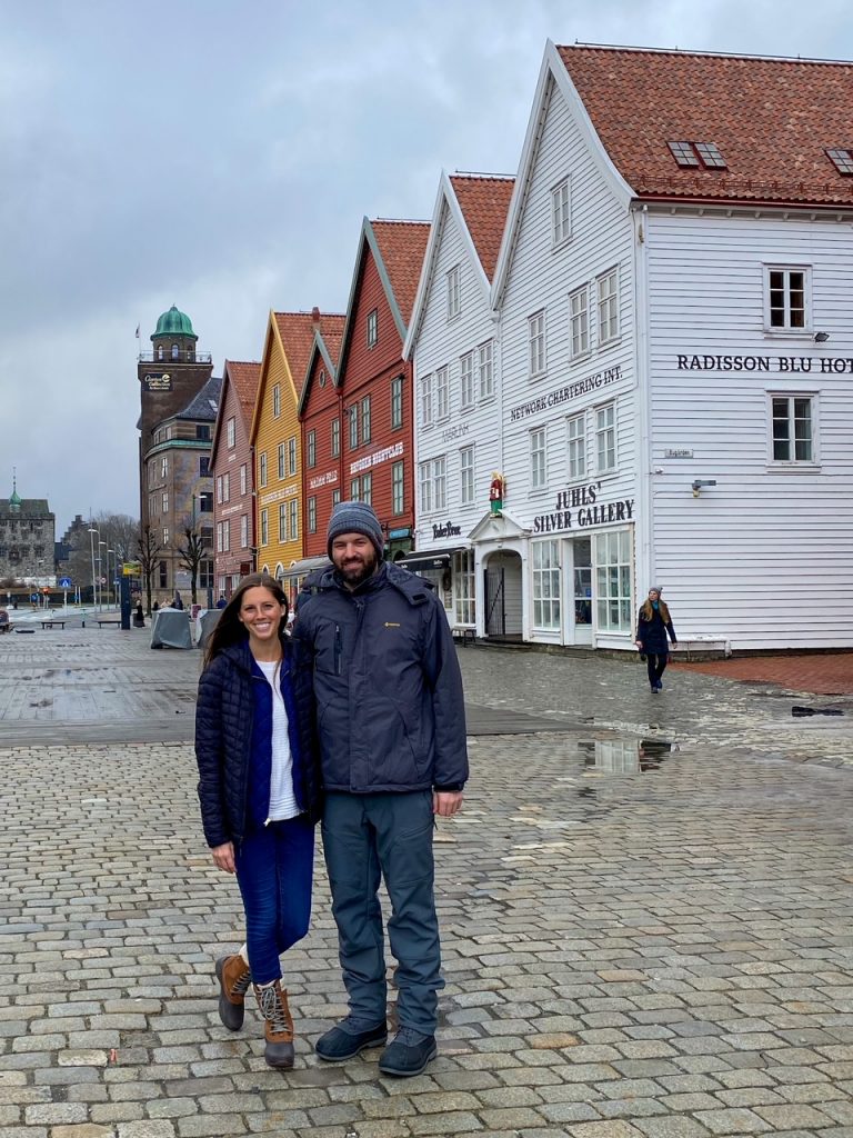 a couple in front of the Bryggen Wharf in Bergen, Norway