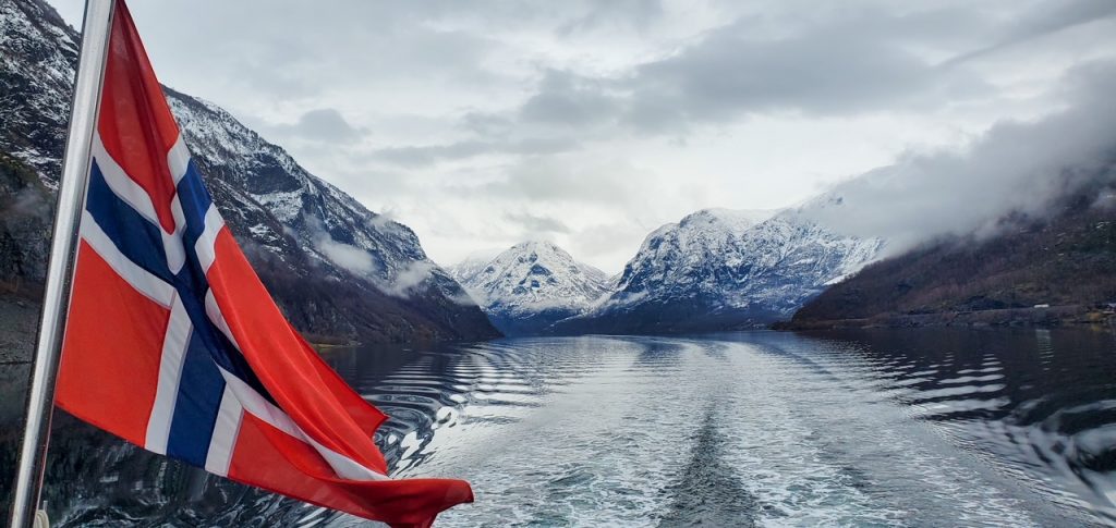 a gorgeous fjord and flag view from the fjord cruise on the way to Flåm