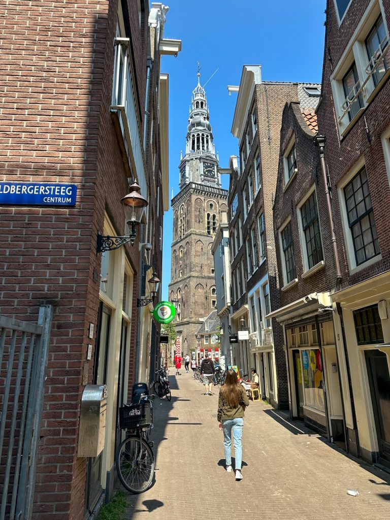 Sara admiring Oude Kerk from a side street
