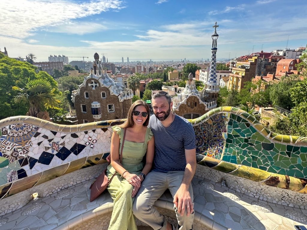 Sara & Tim sitting at Park Güell during their 3 days in Barcelona