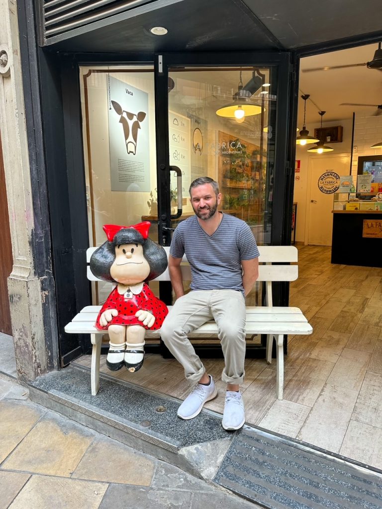 Tim on a bench in Barcelona