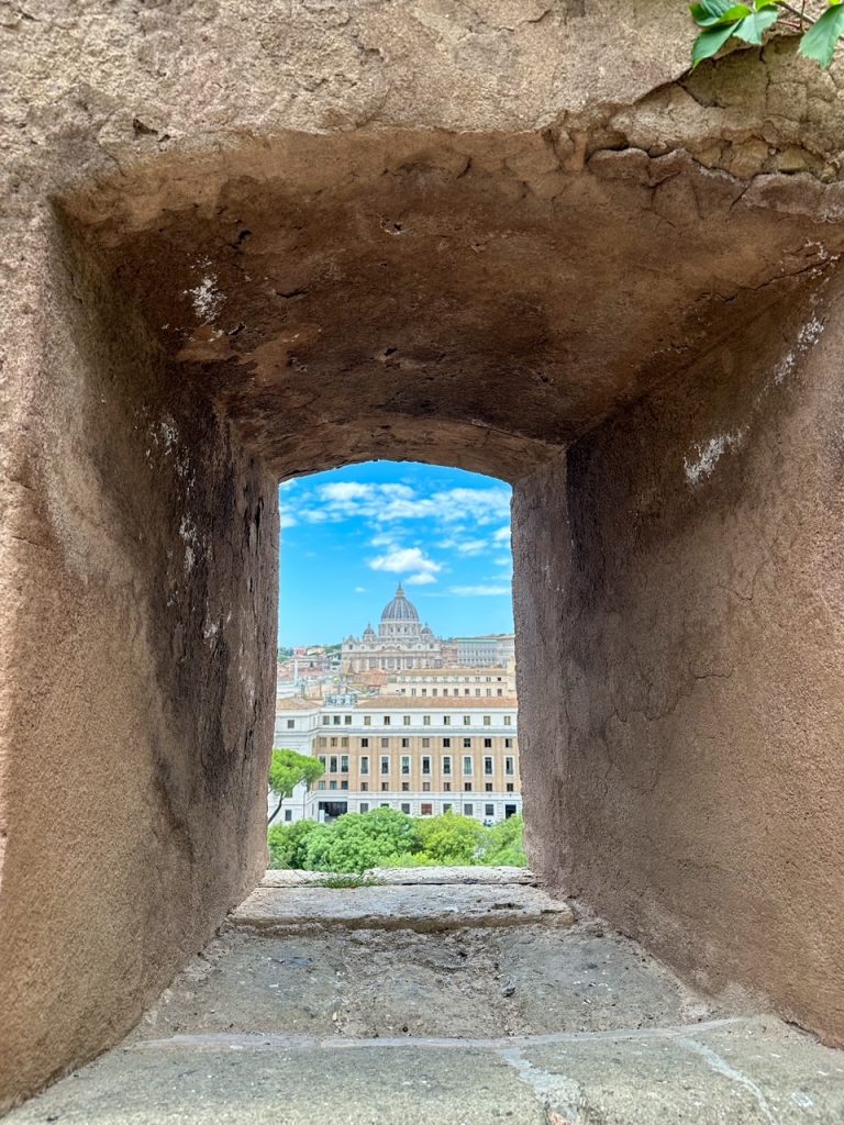 a view of St Peter's Basilica through the walls of Castel Sant'Angelo