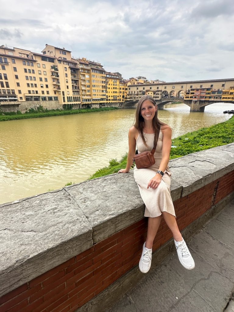 Sara sitting in front of Ponte Vecchio