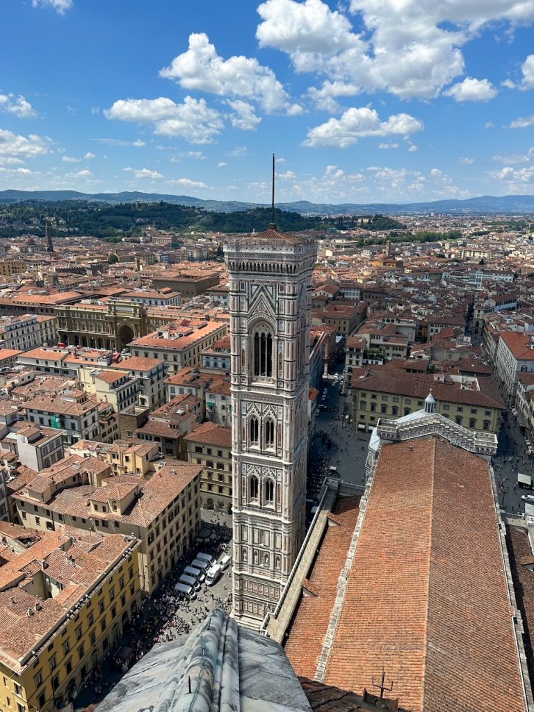 a view of Giotto's Bell Tower from the dome of the Florence Cathedral