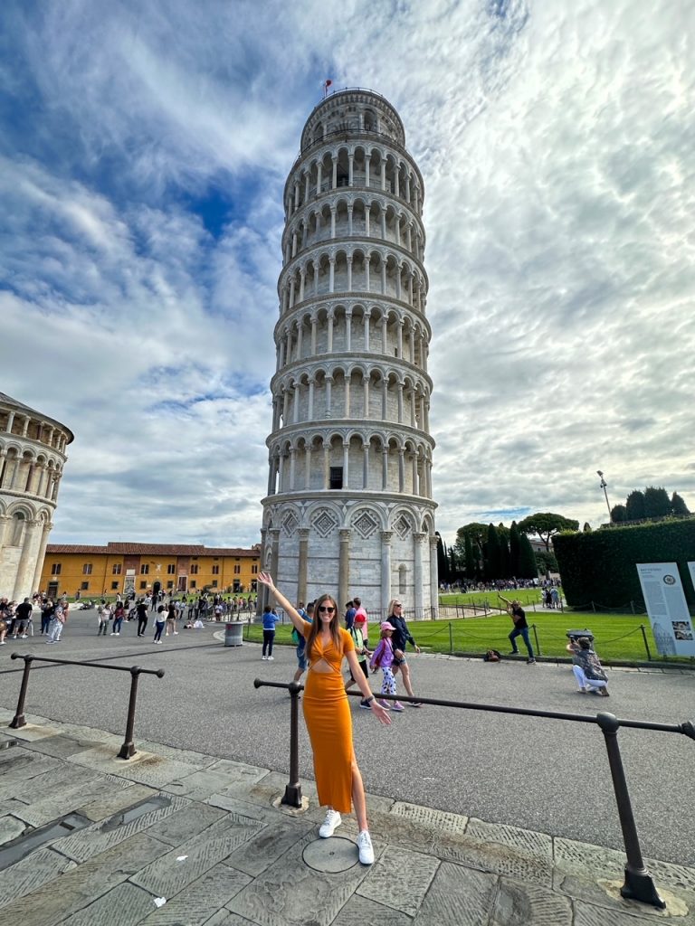 Sara in front of the Leaning Tower of Pisa, an easy add-on to your Florence or 2-week summer Europe itinerary