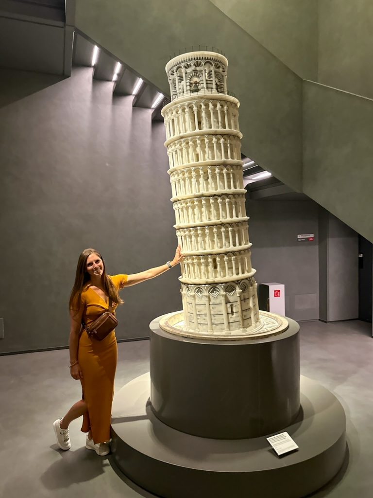Sara with a model of the Leaning Tower of Pisa at the Opera del Duomo Museum