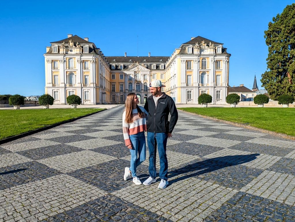 Sara & Tim in front of Augustusburg Palace in Brühl, another one of the best day trips from Frankfurt