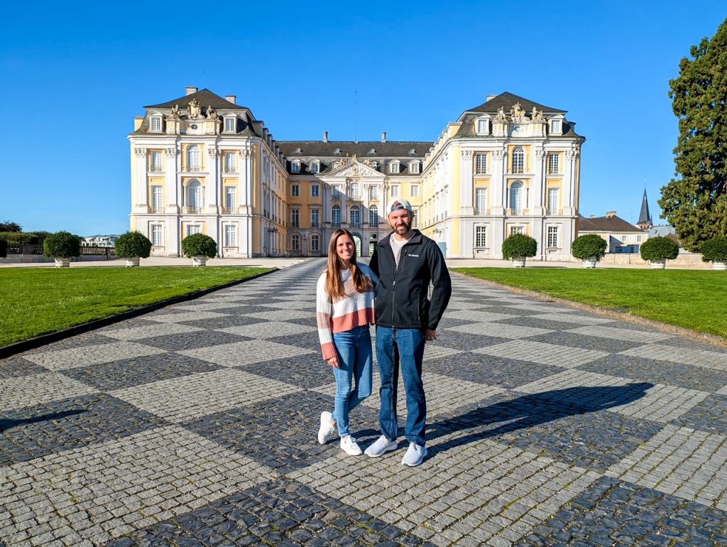 Tourists in front of Augustusburg Palace during their 7 days in Germany