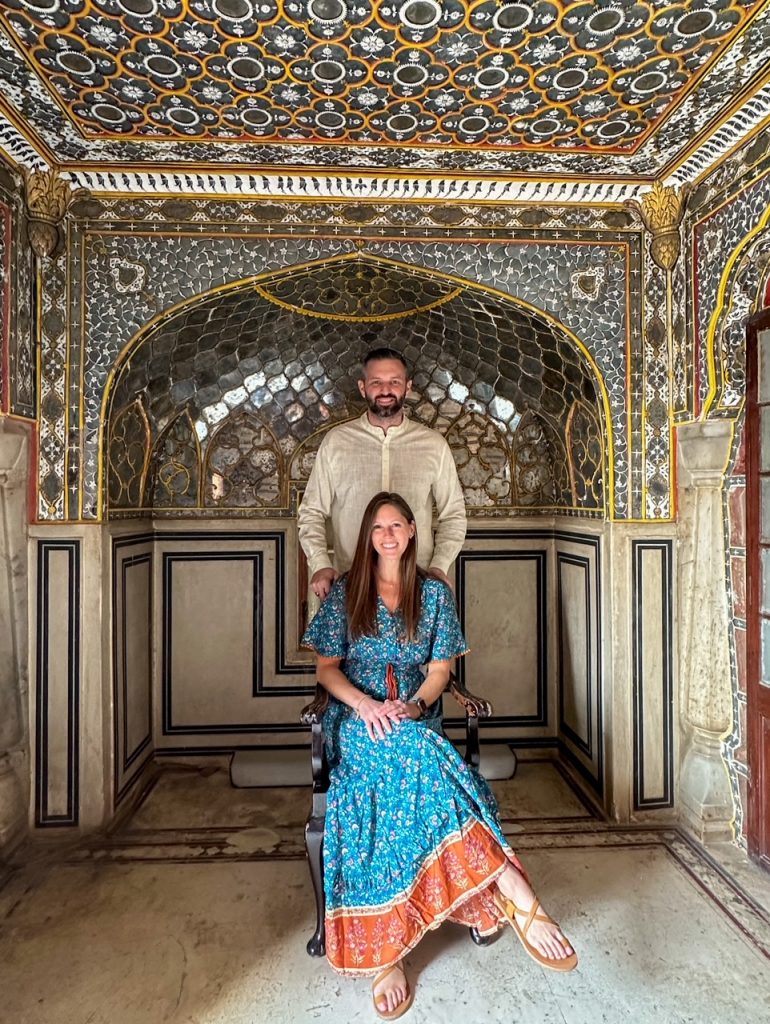 Sara & Tim sitting outside at Rang Mandir at Jaipur City Palace