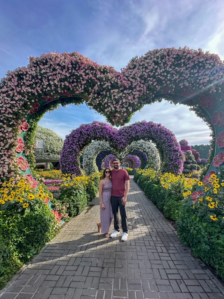 Sara & Tim at the Dubai Miracle Garden, one of the top things to do in Dubai