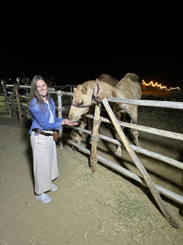 Sara feeding a baby camel in the Dubai Desert