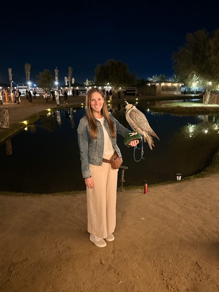 Sara holding a falcon in the Dubai Desert