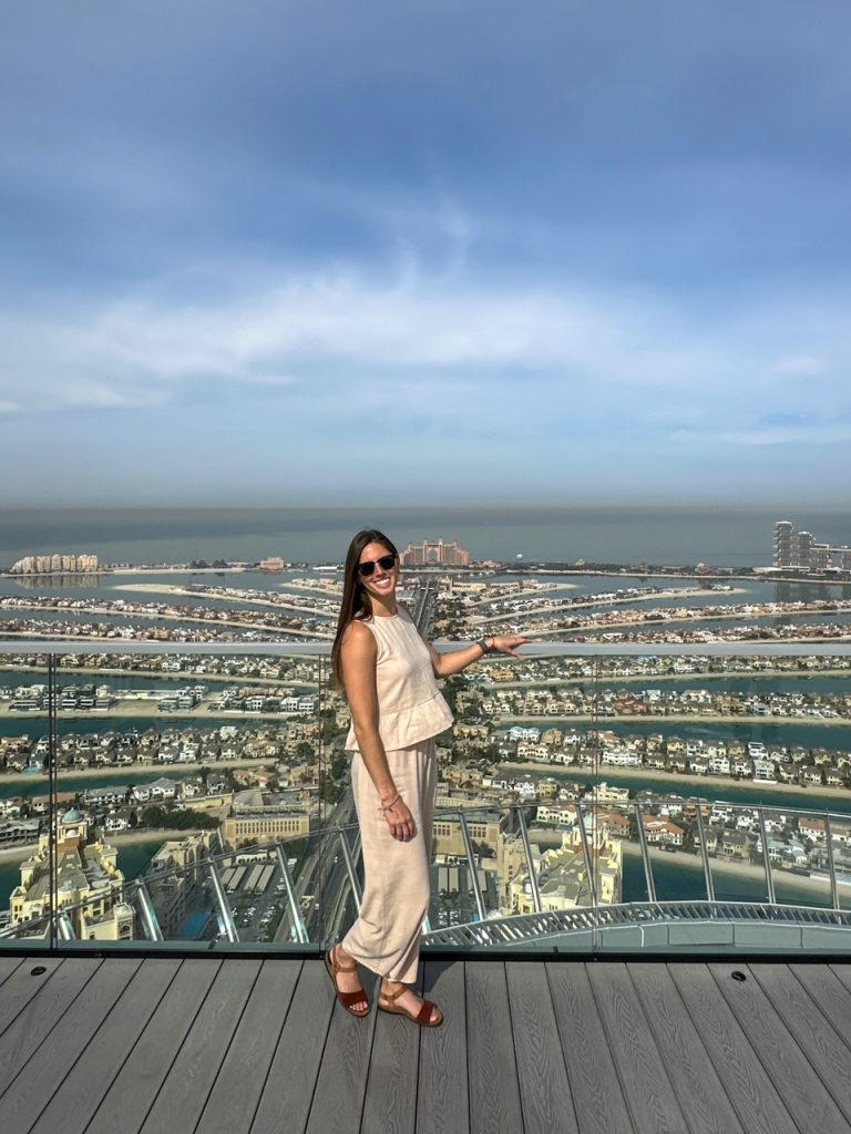 Sara in front of Palm Jumeirah at The View at the Palm, one of the top things to do in Dubai