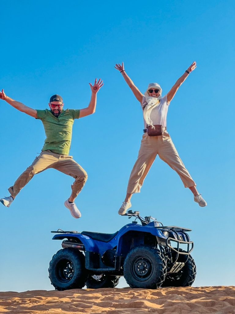 Tim & Sara with their ATV in the Dubai Desert, one of the best things to do in Dubai